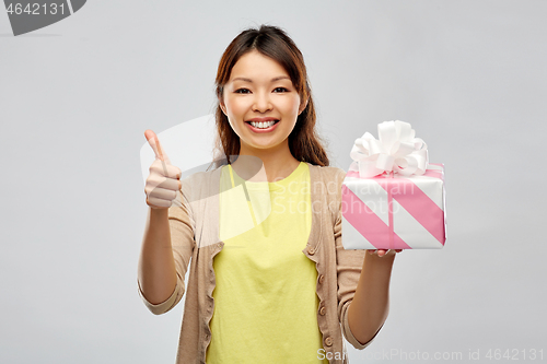 Image of happy african american woman with birthday present