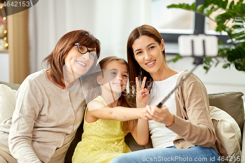 Image of mother, daughter and grandmother taking selfie