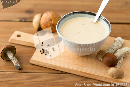 Image of mushroom cream soup in bowl on cutting board