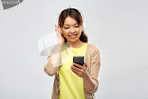 Image of asian woman in headphones listening to music