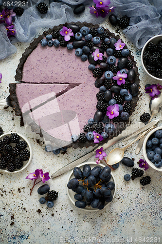 Image of Sweet and tasty tart with fresh blueberries, blackberries and gr