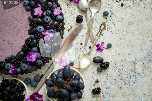 Image of Sweet and tasty tart with fresh blueberries, blackberries and gr