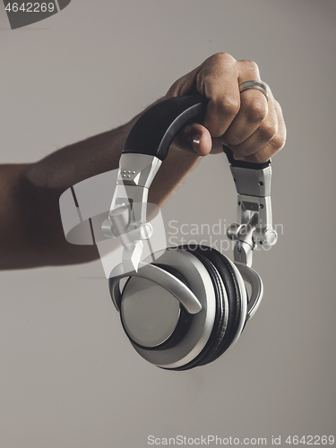 Image of DJ holding him headphones