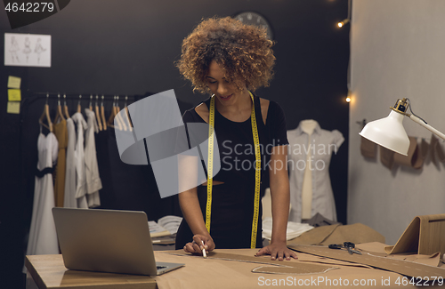 Image of Fashion designer on her Atelier