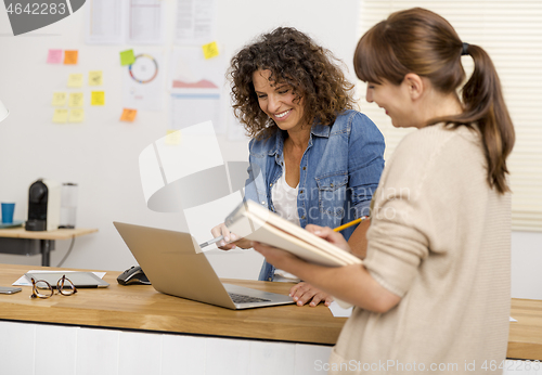 Image of Two businesswoman working together