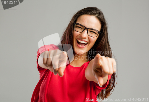 Image of Happy woman pointing to the camera