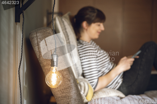 Image of Woman sending a text message