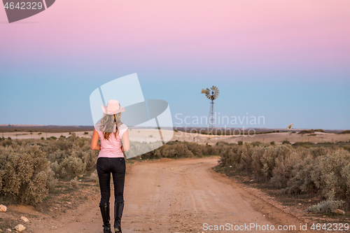 Image of Walking along dirt road of vast open spaces of outback
