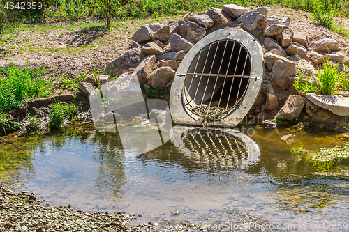 Image of Water drainage pipe prevening from flooding land.