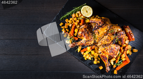 Image of Butterflied grilled whole chicken with roasted vegetables and potatoes 