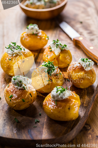 Image of Oven baked potatoes with sour cream with butter and chives