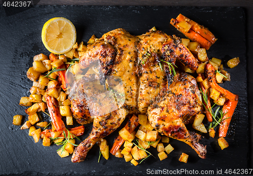 Image of Butterflied grilled whole chicken with roasted vegetables and potatoes 