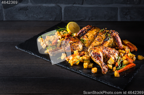 Image of Butterflied grilled whole chicken with roasted vegetables and potatoes 