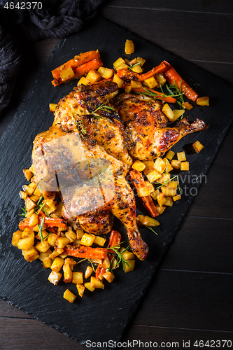 Image of Butterflied grilled whole chicken with roasted vegetables and potatoes 