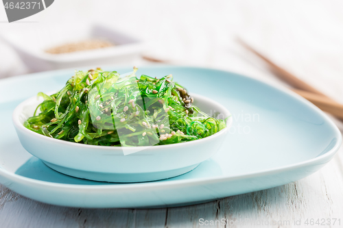 Image of Traditional Japanese wakame salad with sesam seeds. Healthy seaweed salad.