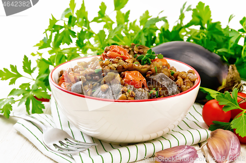 Image of Lentils with eggplant in bowl on light board