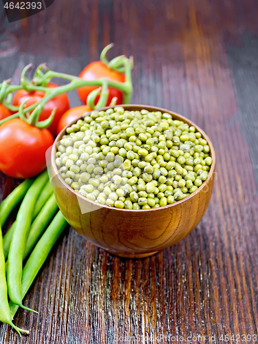 Image of Mung beans  in bowl with vegetables on dark wooden board