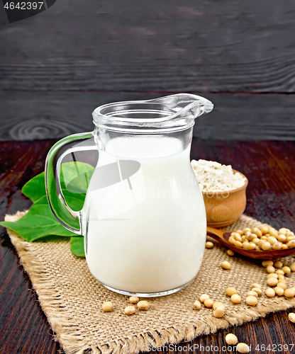 Image of Milk soy in jug with flour on board