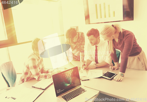 Image of startup business team on meeting at modern office with sunset in