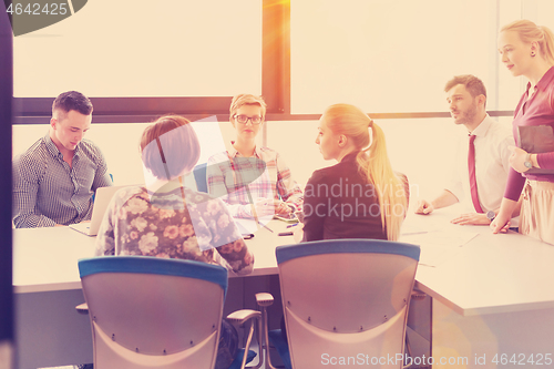 Image of startup business team on meeting at modern office with sunset in