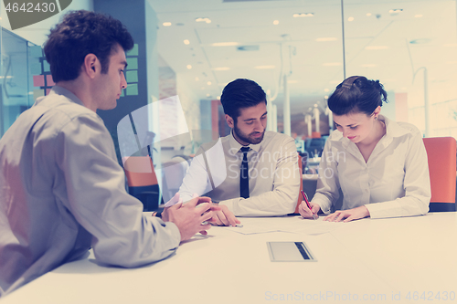 Image of young couple signing contract documents on partners back