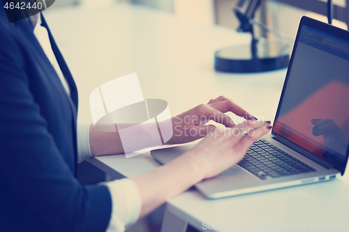 Image of business woman working on computer at office