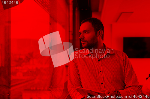 Image of Businessman Using Tablet In Office Building by window