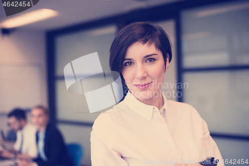 Image of hispanic businesswoman with tablet at meeting room