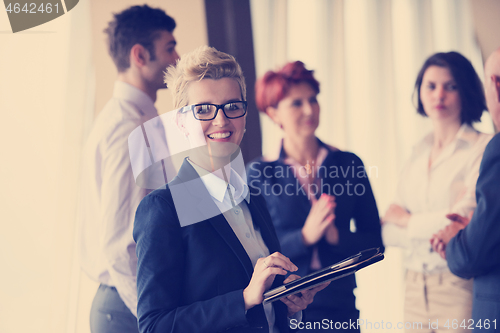 Image of portrait of older business woman  at office with tablet computer