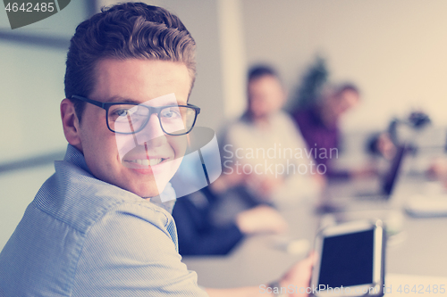 Image of Businessman using tablet in modern office