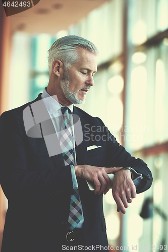 Image of senior business man talk on mobile phone