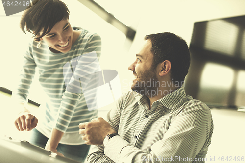 Image of Two Business People Working With Tablet in startup office