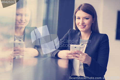 Image of Business Girl Standing In A Modern Building Near The Window With