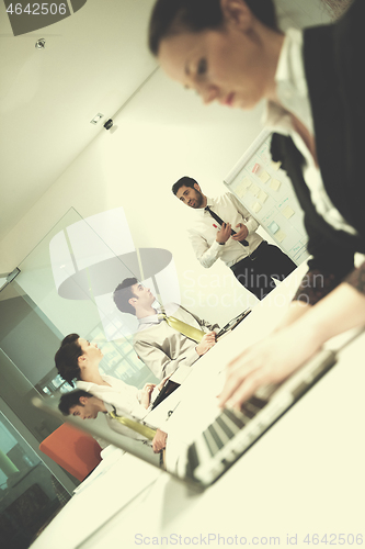 Image of young business woman on meeting  using laptop computer