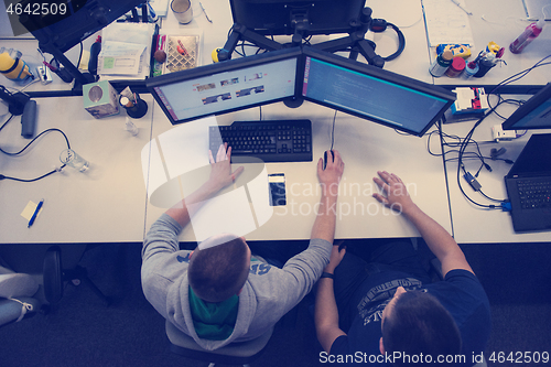 Image of young programmers writing programming code top view