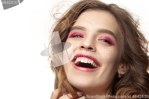 Image of Nice young smiling woman with long wavy silky hair, natural make up looking at camera