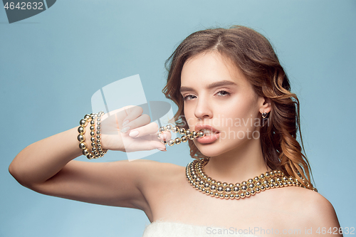 Image of Beautiful young girl in studio with pearl jewelry - earrings, bracelet, necklace.