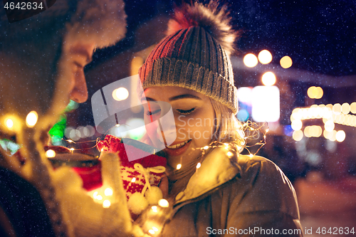 Image of Adult couple hanging out in the city during Christmas time