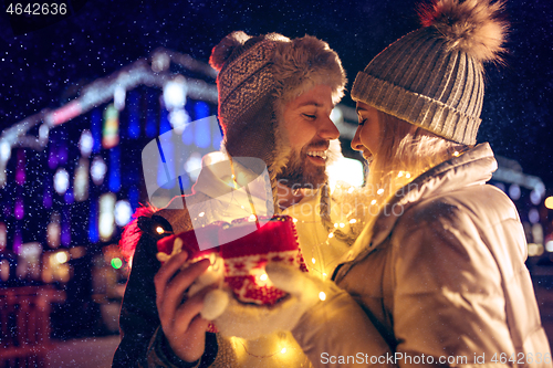 Image of Adult couple hanging out in the city during Christmas time