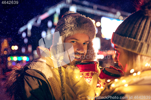 Image of Adult couple hanging out in the city during Christmas time