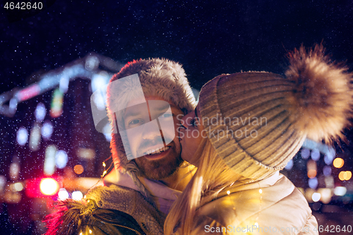 Image of Adult couple hanging out in the city during Christmas time