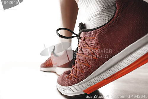 Image of Portrait of young sporty woman at starting block of race isolated over white background