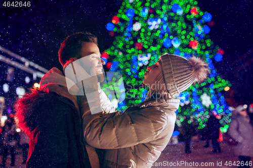 Image of Adult couple hanging out in the city during Christmas time