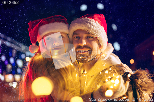 Image of family, christmas, holidays, season and people concept - happy family over city background and snow