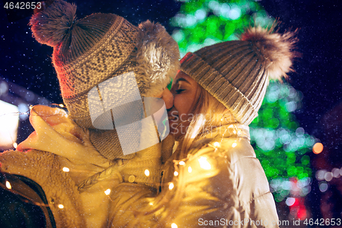 Image of Adult couple hanging out in the city during Christmas time