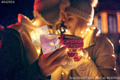 Image of Adult couple hanging out in the city during Christmas time