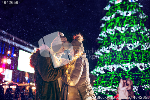 Image of Adult couple hanging out in the city during Christmas time