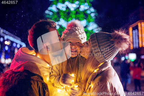 Image of family, christmas, holidays, season and people concept - happy family over city background and snow