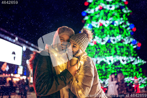 Image of Adult couple hanging out in the city during Christmas time