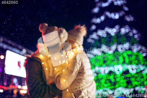 Image of Adult couple hanging out in the city during Christmas time